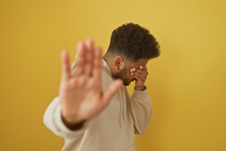 African american man in casual wear expressing rejection with a stop gesture against a yellow isolated background
