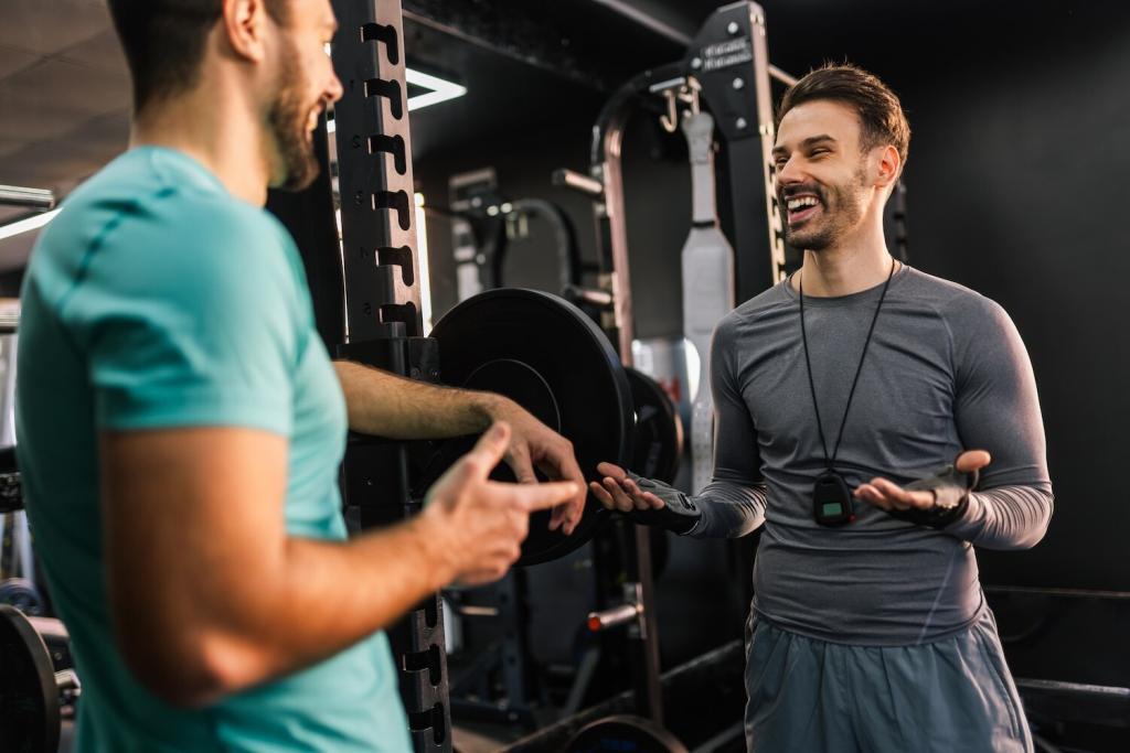 Athletic man talking with a personal trainer in the gym