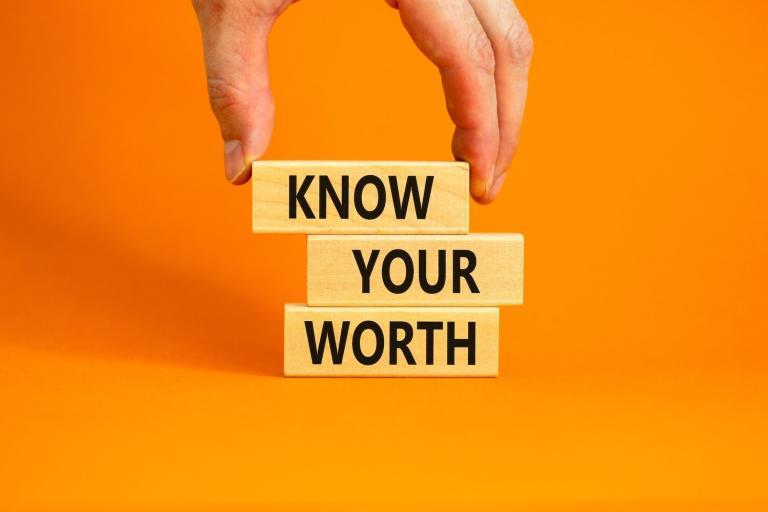 Three blocks with words on them that say "know your worth" with an orange background
